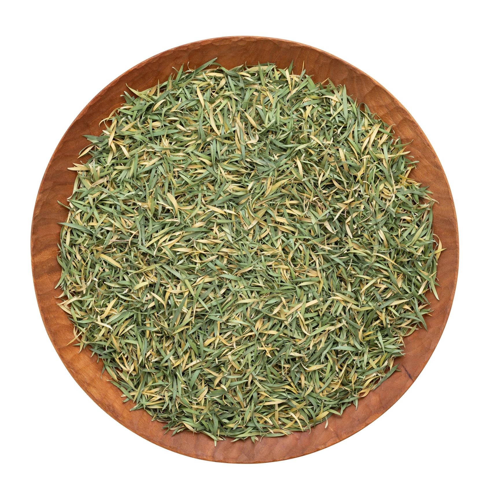 Fresh green leaves arranged in a handmade wooden dish